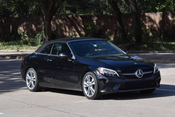 Luxury Mercedes S-Class with chauffeur parked in London’s business district.